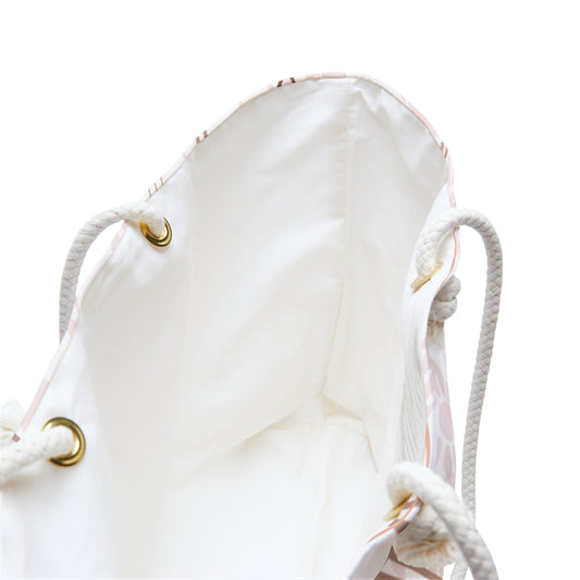 Inside view of a white drawstring bag with gold accents on a white background