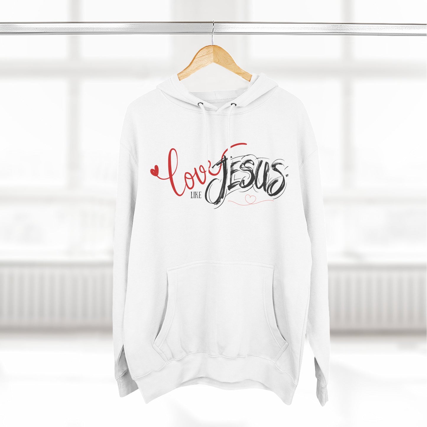 White hoodie with 'Love like Jesus' text on a hanger against a white background