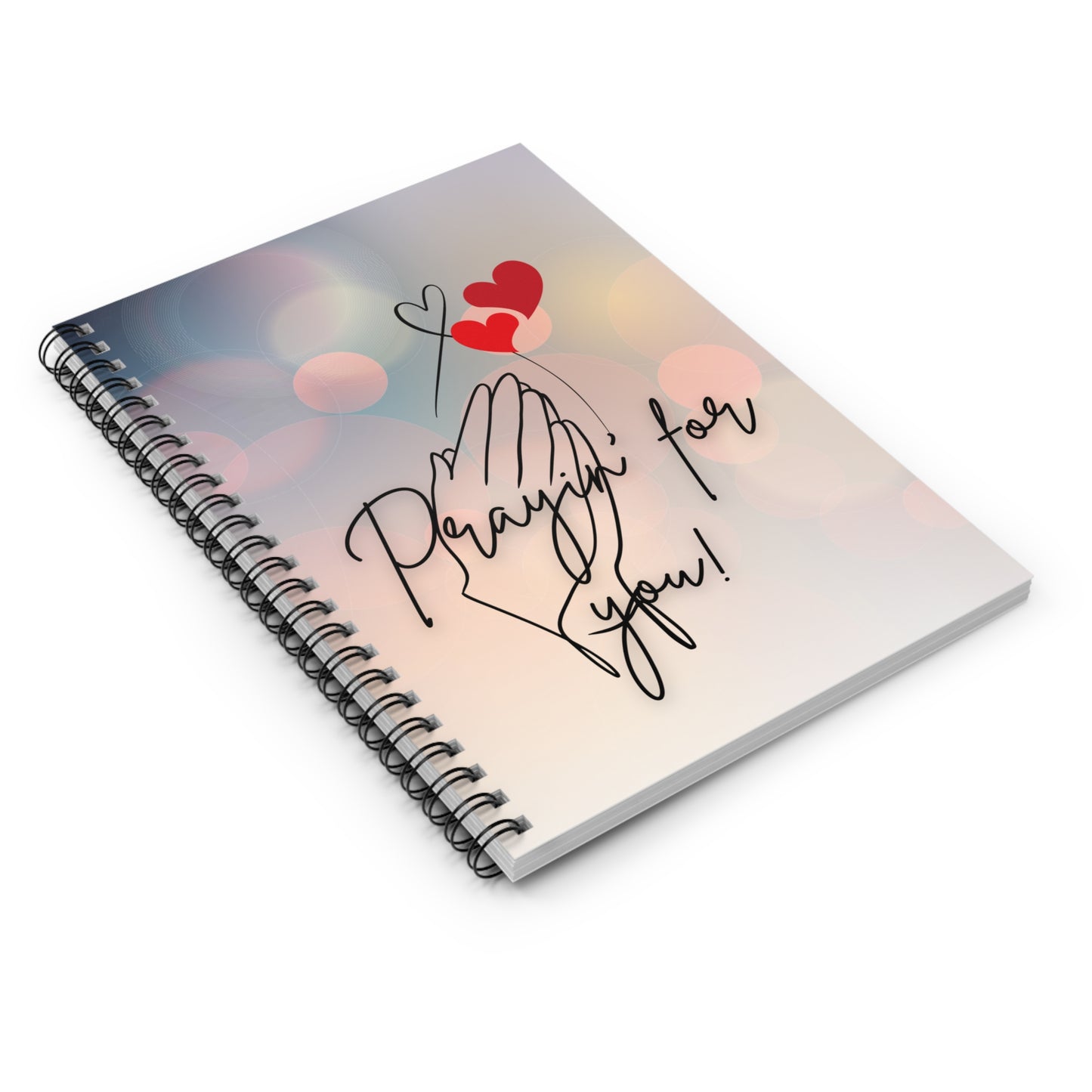 Notebook with 'Prayin' for you' text and hearts on a gradient background