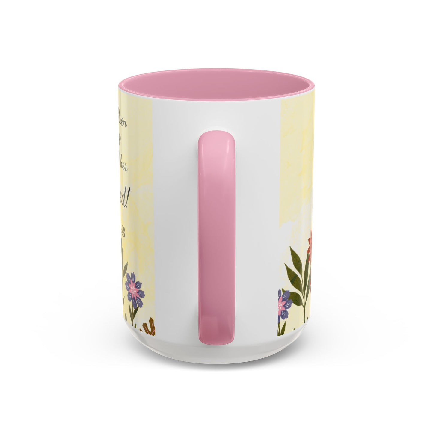 Mug with pink handle and floral design on a white background