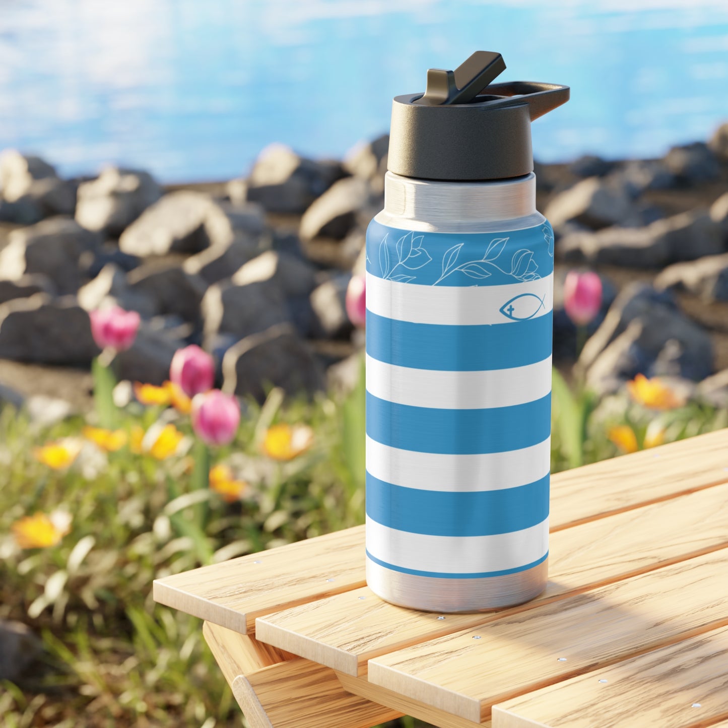 Blue and white striped water bottle on a wooden table with a scenic background