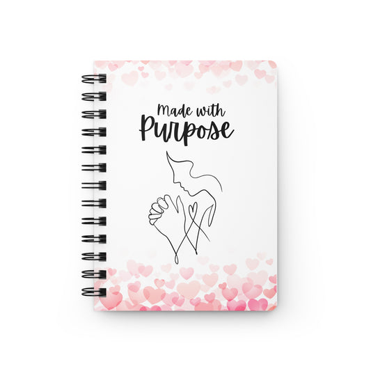 Notebook with 'Made with Purpose' text and heart design on a white background
