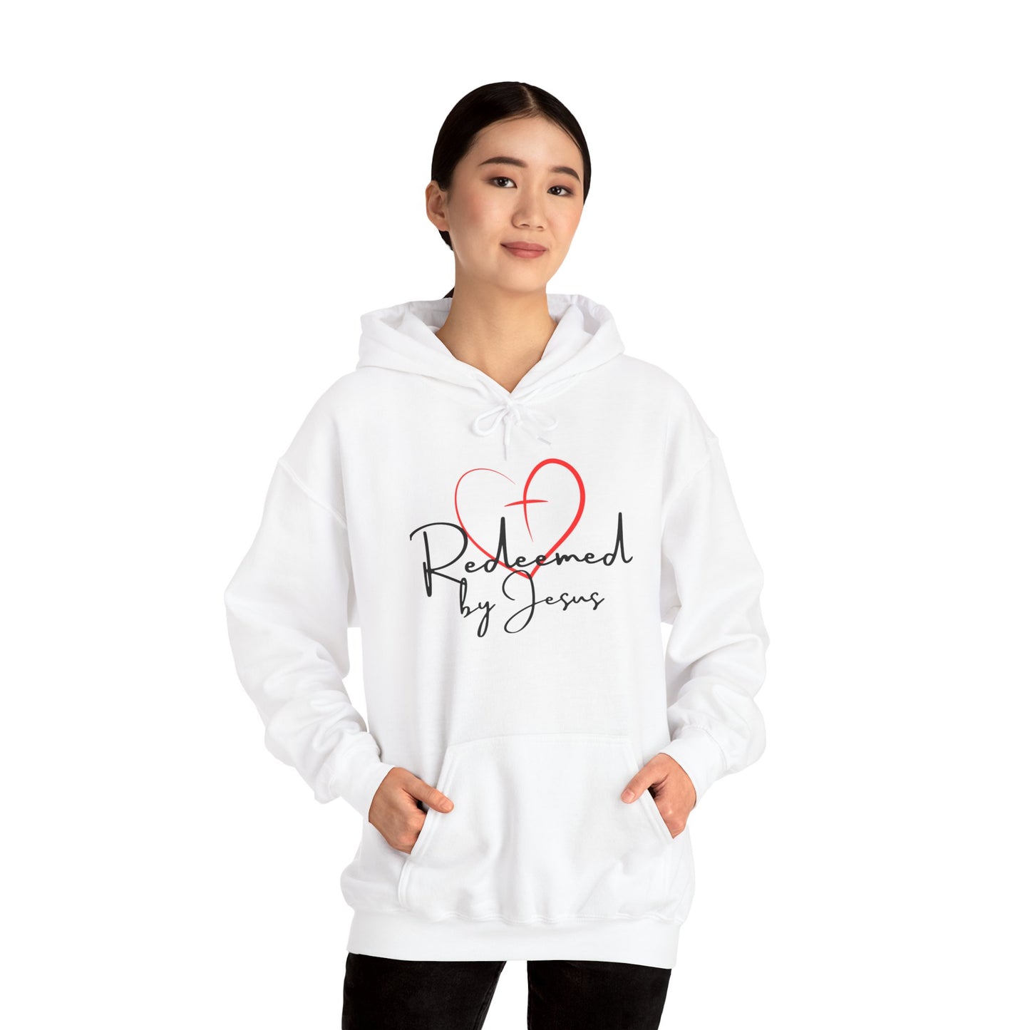 Person wearing a white hoodie with 'Redeemed by Jesus' text and heart design on a white background