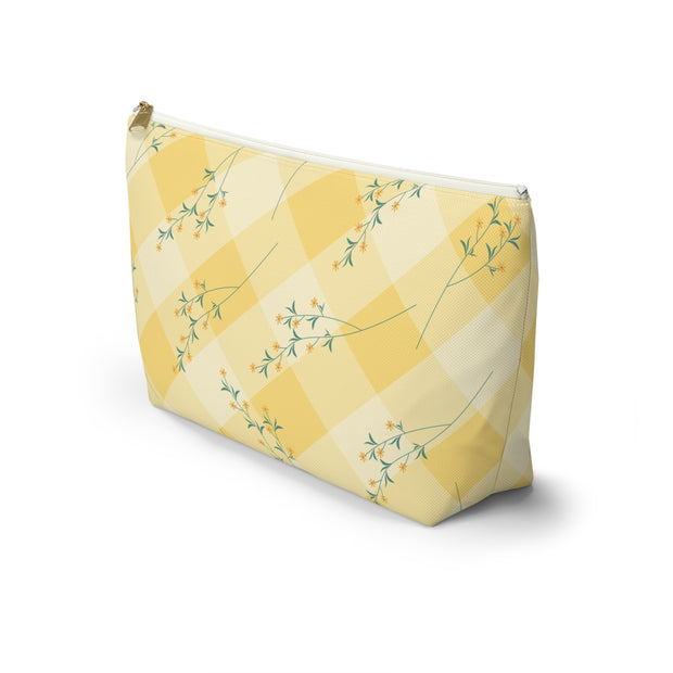 Yellow cosmetic bag with floral pattern on a white background