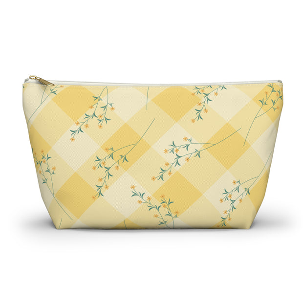 Yellow checkered pouch with floral patterns on a white background