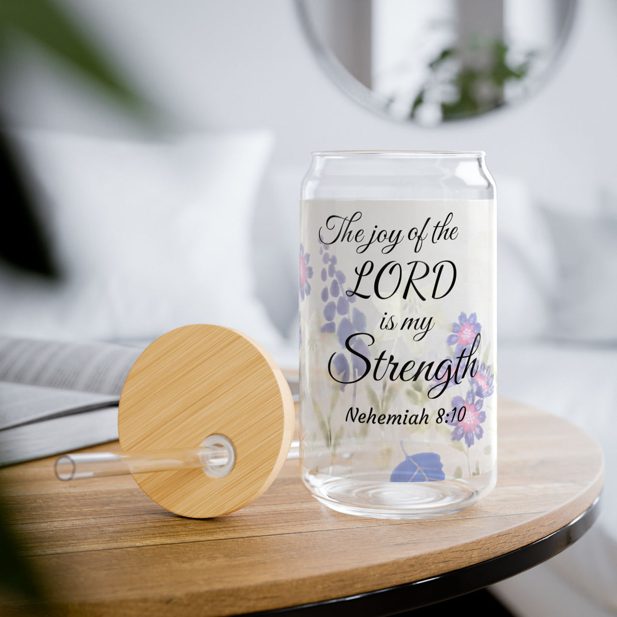 Glass tumbler with a faith-inspiring  Bible quote on a wooden table