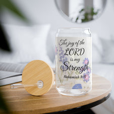 Glass tumbler with a faith-inspiring  Bible quote on a wooden table