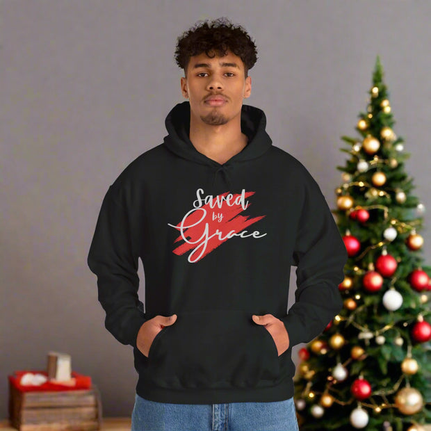 Person wearing a black hoodie with 'Saved by Grace' text on a white background