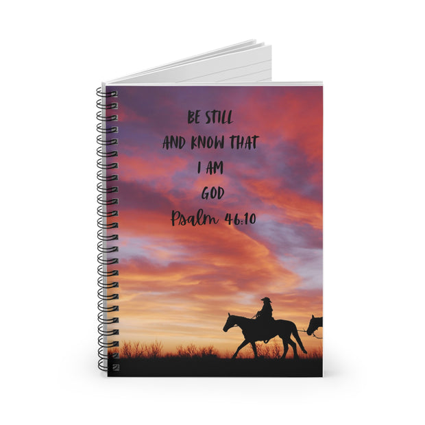 Notebook with a sunset design and text, featuring two people on horses.
