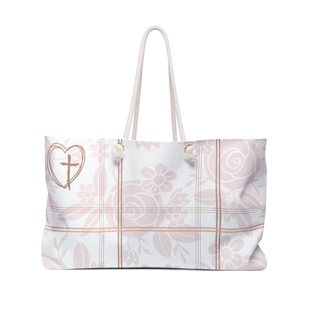 White tote bag with floral and cross design on a white background