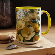 Floral mug with yellow flowers on a wooden surface with coffee beans and a macaron.