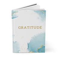 Book titled 'Gratitude' with a blue and gold design on a white background