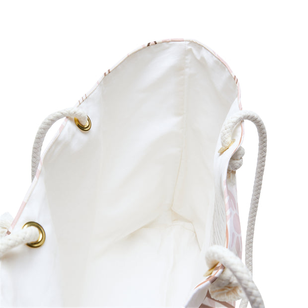 Inside view of a white drawstring bag with gold accents on a white background