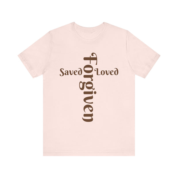 Pink t-shirt with 'Saved Loved Forgiven' text on a white background