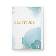 Notebook with 'Gratitude' text on a blue and gold abstract design cover