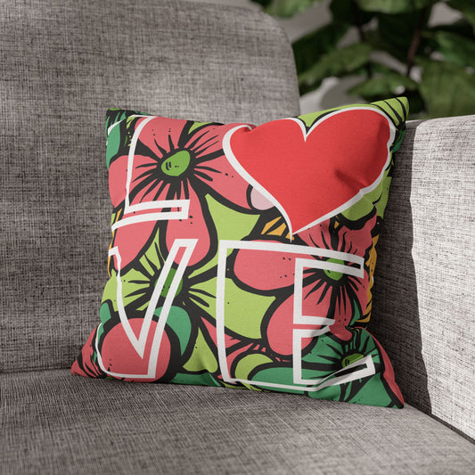 Decorative pillow with floral and heart design and the word Love on a gray couch