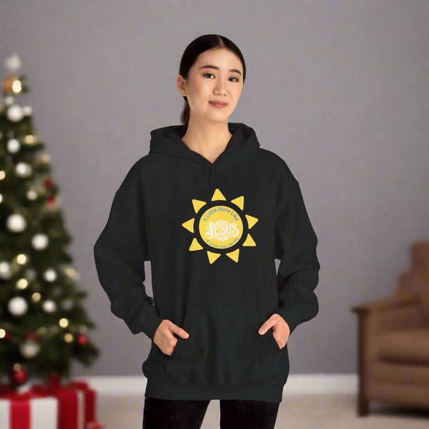 Person wearing a black hoodie with a yellow sun design on a white background
