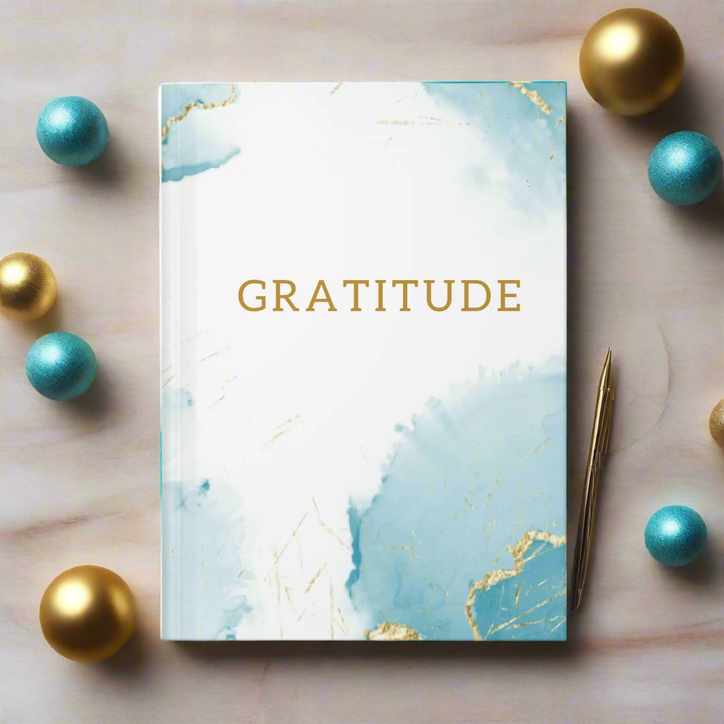 Hardback journal with teal, white and gold marble design with the word 