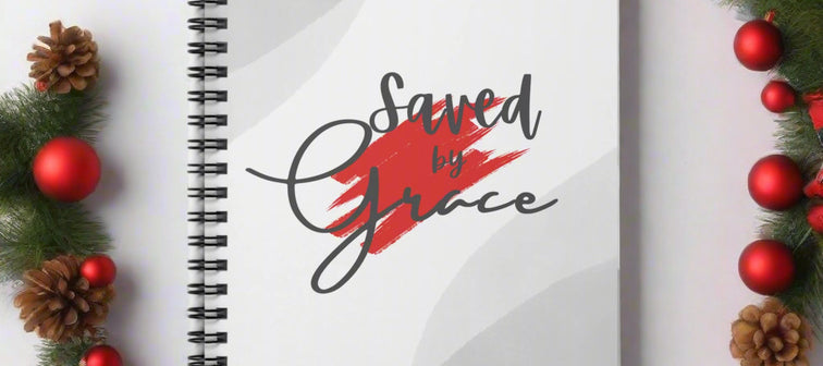 Notebook with 'Saved by Grace' text on a white background