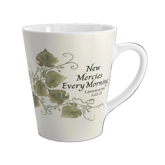 White mug with green leaf design and text on a white background