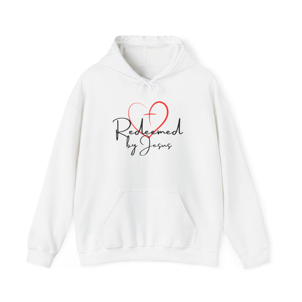White hoodie with 'Redeemed by Jesus' text and red heart design on a white background