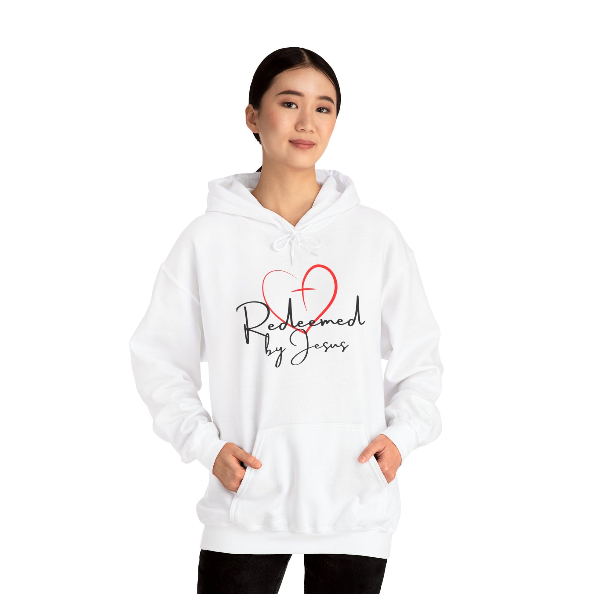 Person wearing a white hoodie with 'Redeemed by Jesus' text and heart design on a white background